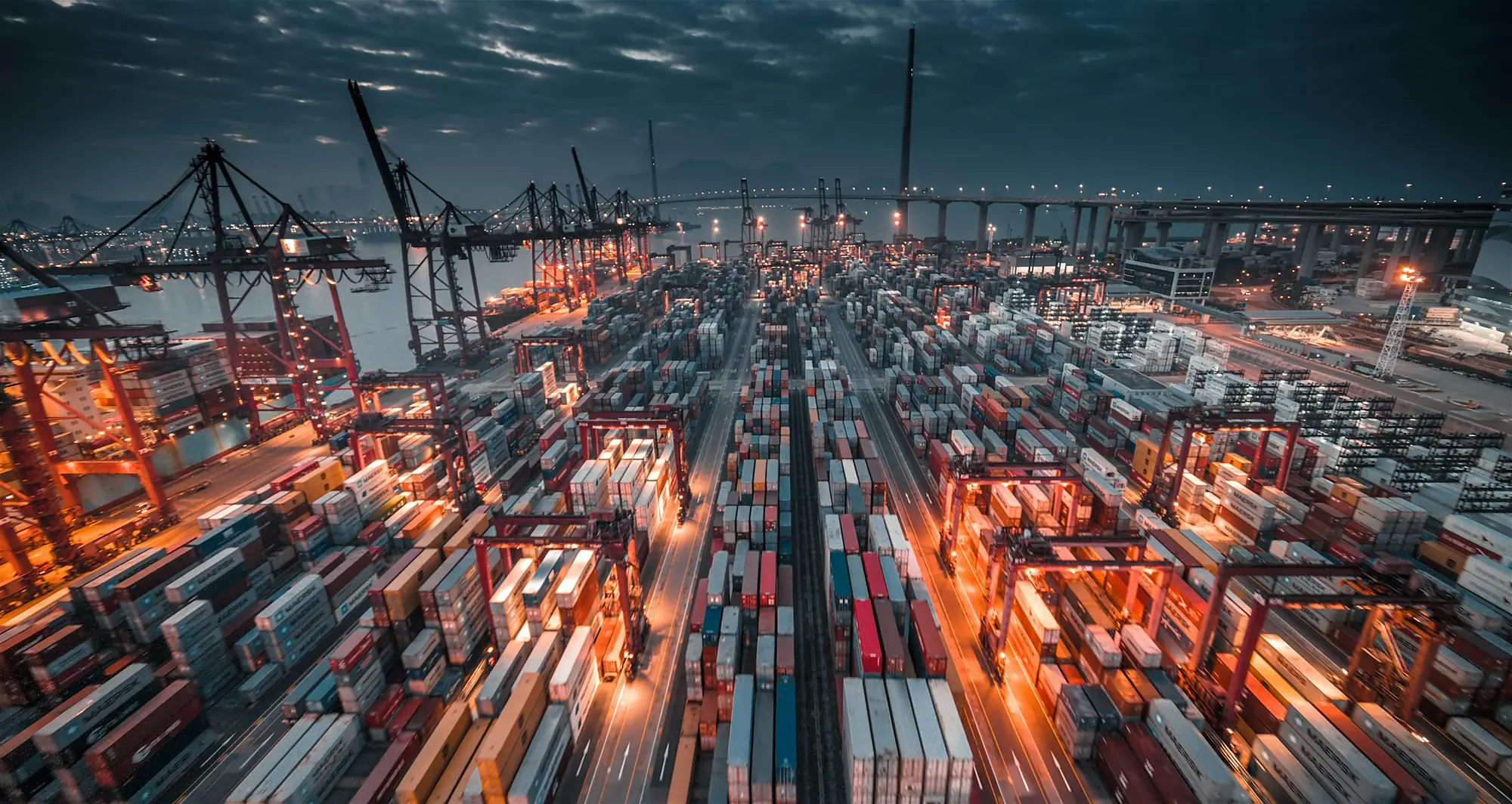 Container terminal at night with long-exposure light trails
