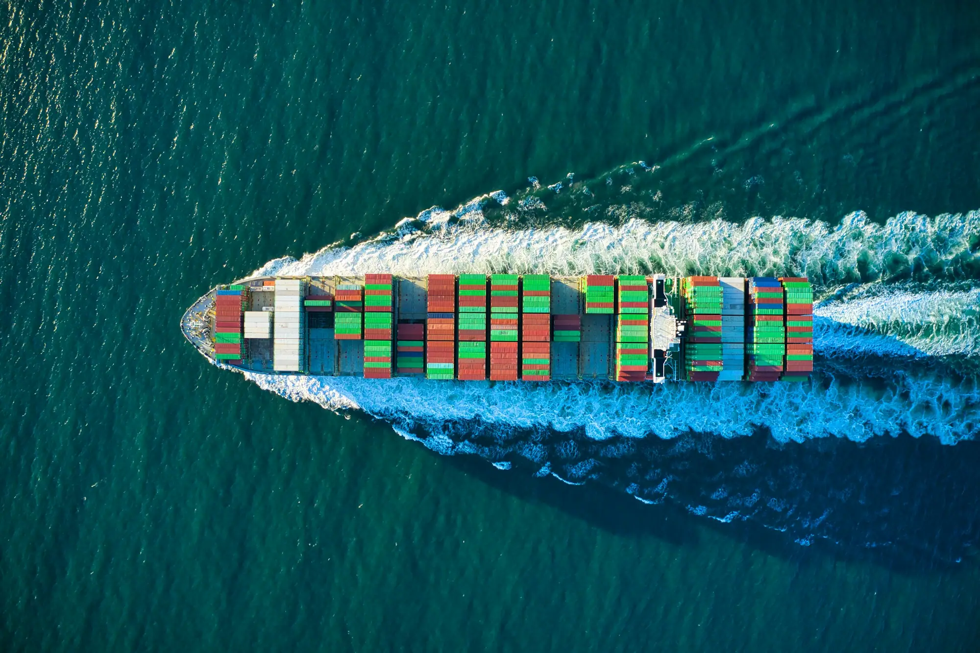 Aerial view of a cargo ship crossing open ocean