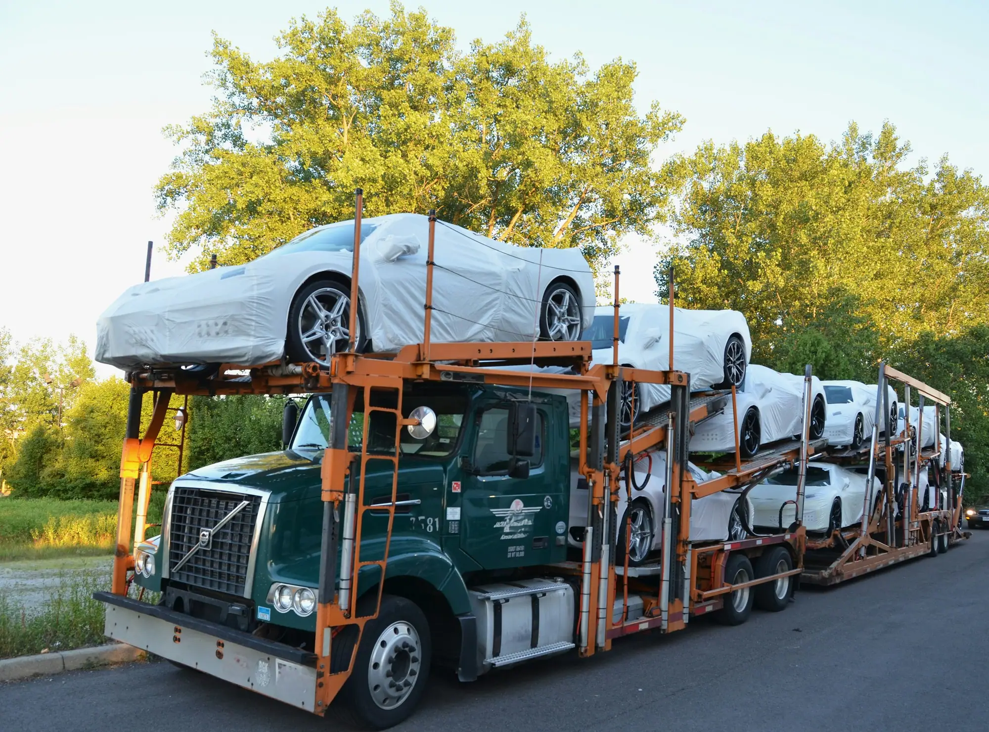 Car transporter truck carrying covered vehicles